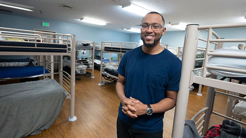 Industrial workers in protective gear responding to weather alert in manufacturing yard